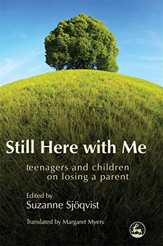 Book cover with a tree on a hill, titled “Still Here with Me.”