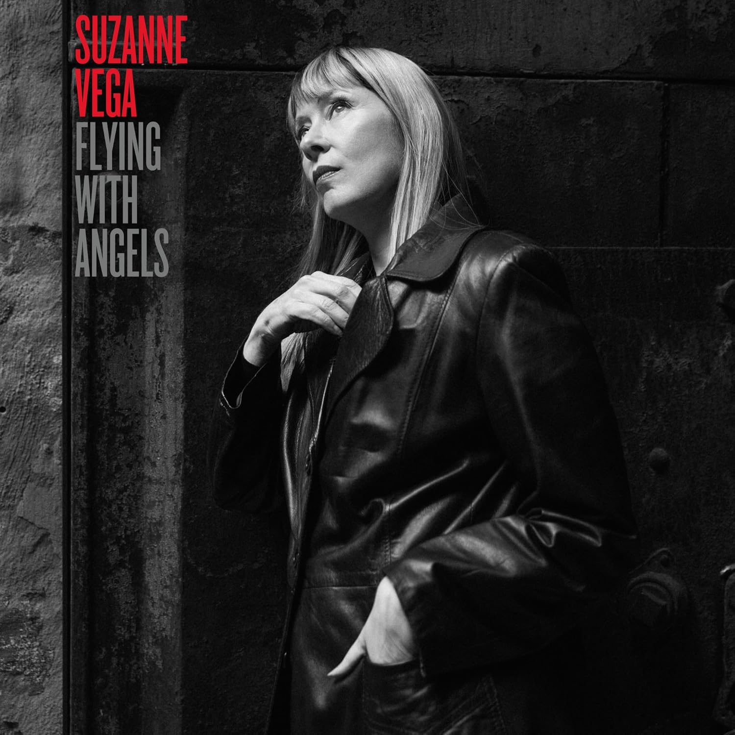 Black and white album cover featuring Suzanne Vega looking upwards.