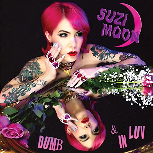 Suzi Moon album cover with pink hair, tattoos, and floral arrangement.