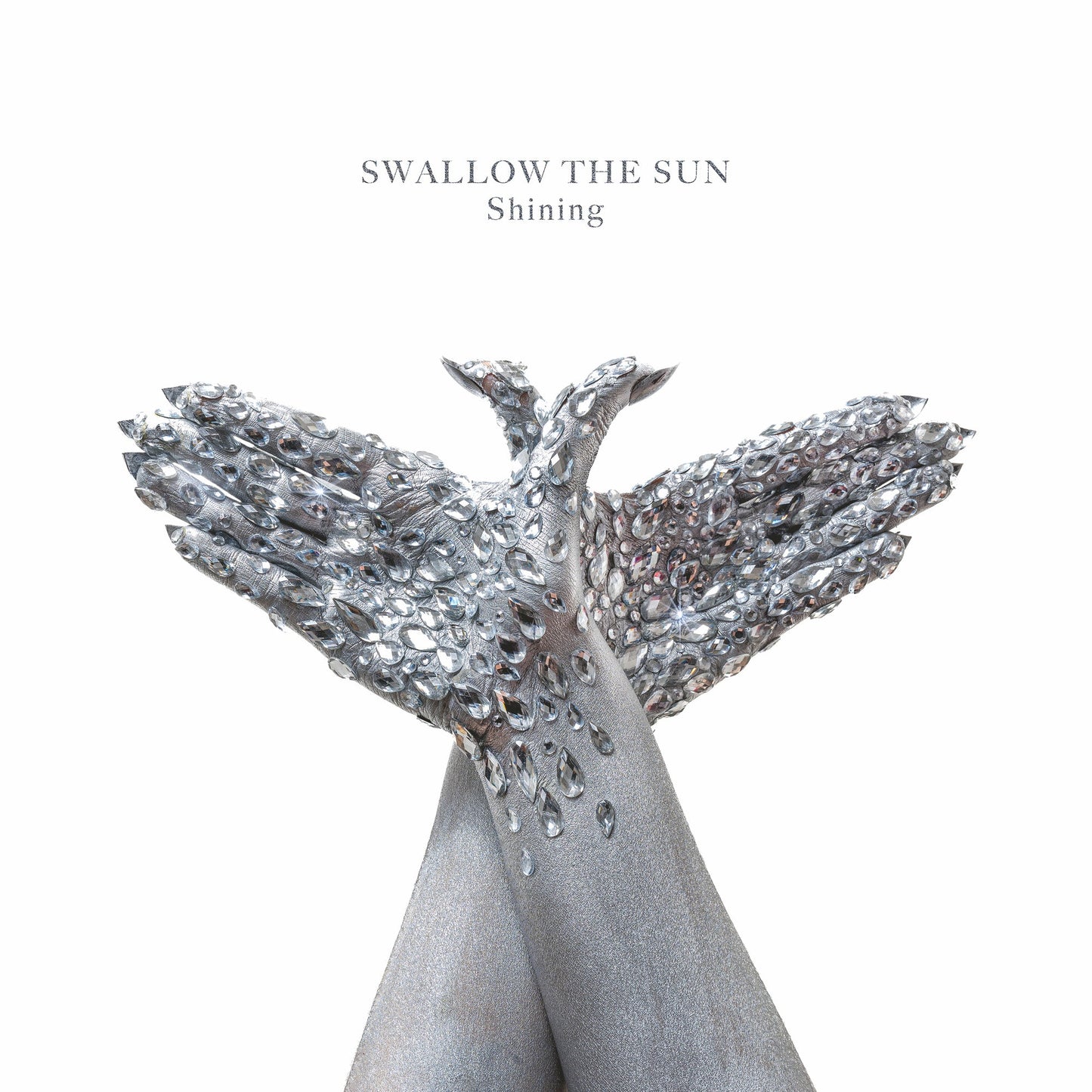 Album cover for Swallow The Sun’s “Shining” featuring a jeweled bird sculpture.