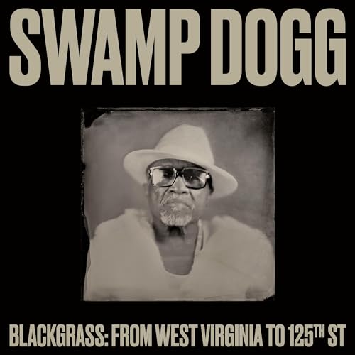 Swamp Dogg wearing a hat and glasses in a vintage-style portrait on black background.