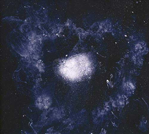 A bright, glowing cluster of white light surrounded by wispy, dark blue cosmic clouds.