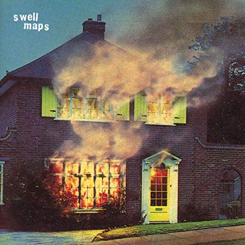 Burning two-story brick house with smoke, album cover for Swell Maps.