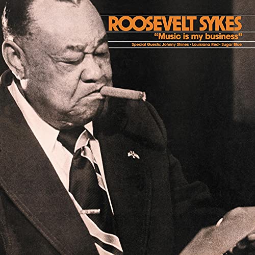 Roosevelt Sykes in a suit and tie, smoking a cigar, on a vinyl album cover.