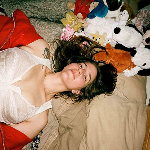 Syko Friend album cover: woman lying among stuffed animals.