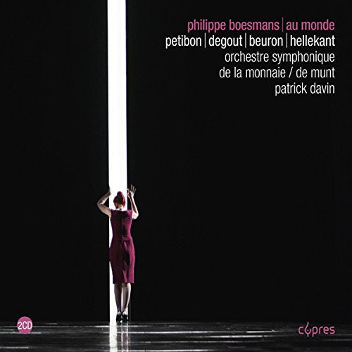A woman in a red dress stands in a white beam of light on a dark stage.