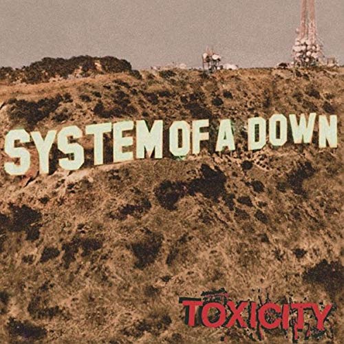 System of a Down written in large letters on a hillside with Toxicity below.