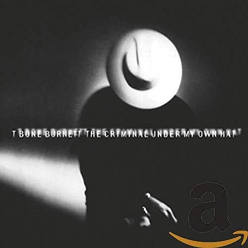 Black and white image of a man in a hat with album title text.