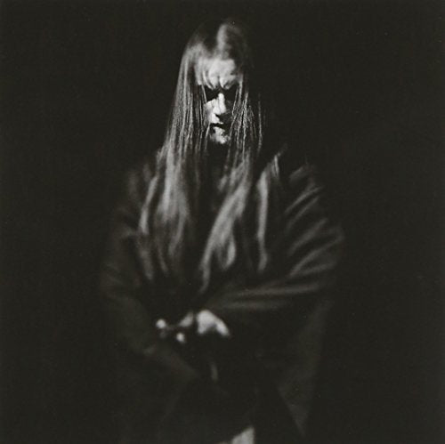 Black and white portrait of a person with long hair and corpse paint.