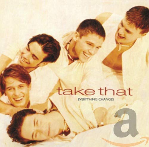 Take That band members smiling on album cover, with text and logo.