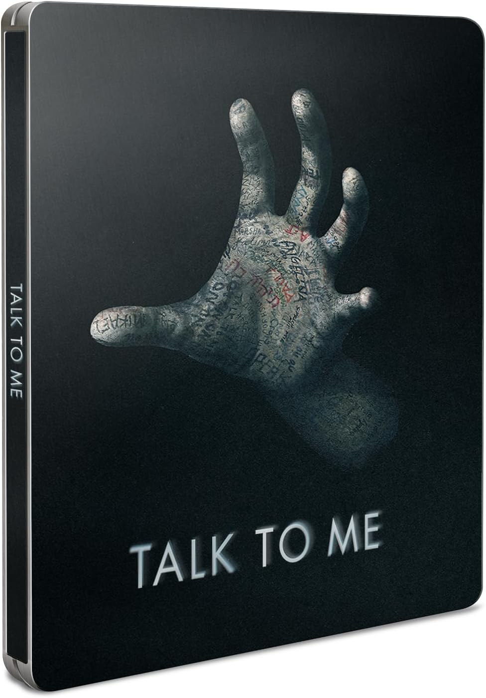 “Talk to Me” Steelbook cover with a hand and writing imagery.