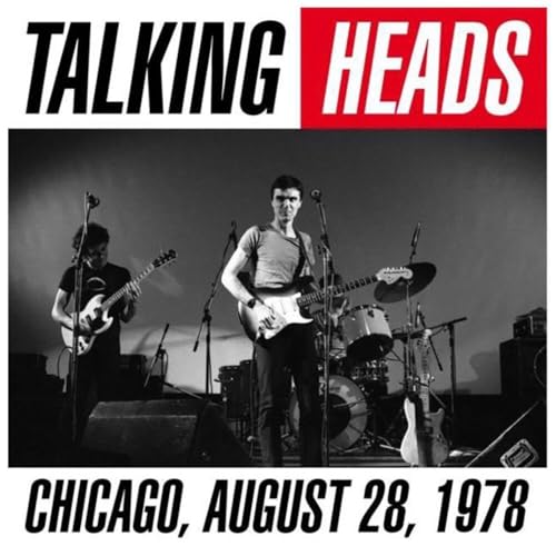Black and white photo of Talking Heads performing live on stage in Chicago.