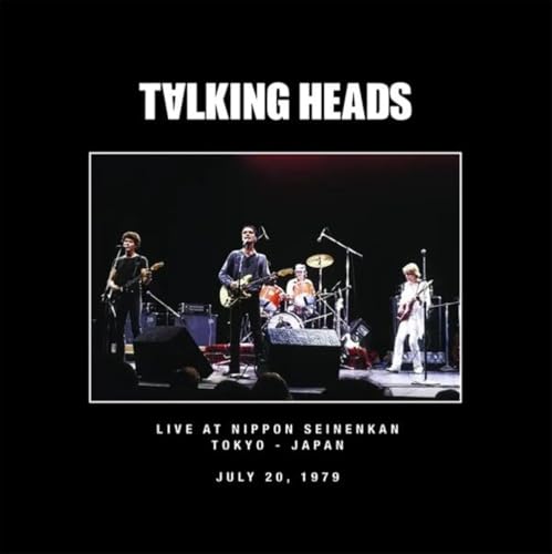 Talking Heads band performing live on stage, black and white photo.