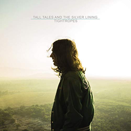The image depicts a vinyl record cover featuring a man standing in a landscape. For accessibility purposes, a suitable alt text could be: "Vinyl record cover with a man in a green jacket."