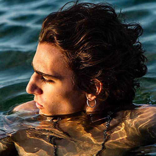 Close-up of a young man with long hair, partially submerged in water.