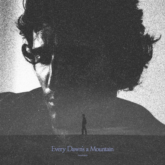 Black and white album cover featuring a man’s face and distant landscape.