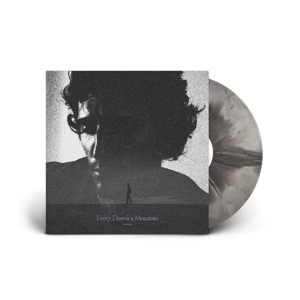 Black and white album cover featuring a man’s face dissolving into a mountain.
