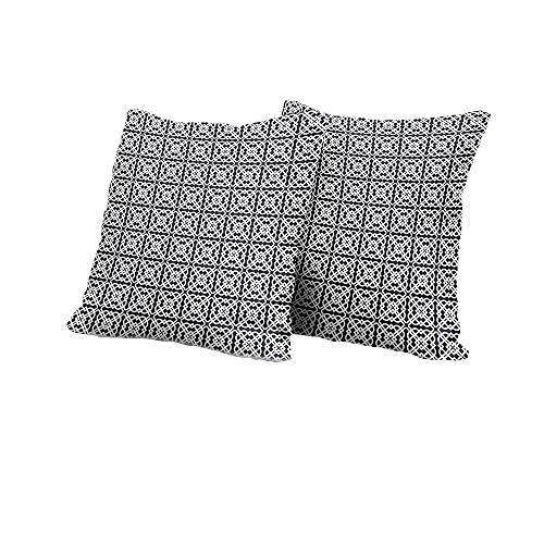Two black and white patterned square pillows stacked against a white background.