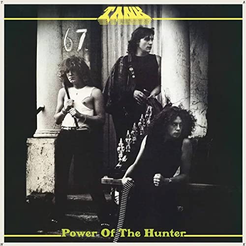 Tank album cover: three people in front of a doorway, black and white.