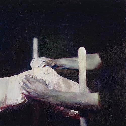 Dark, painterly image of hands and white objects against a black background.