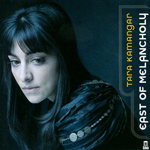 "CD album cover featuring a woman with long dark hair against a dark background."