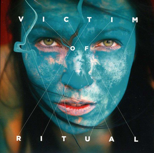 Close-up of a woman’s face with blue skin and geometric lines.