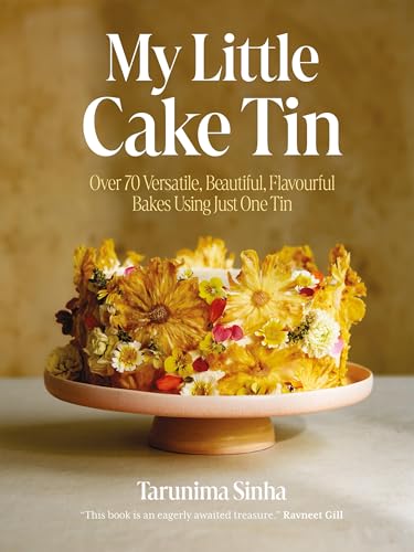 Cookbook cover featuring a decorated cake on a pink pedestal.