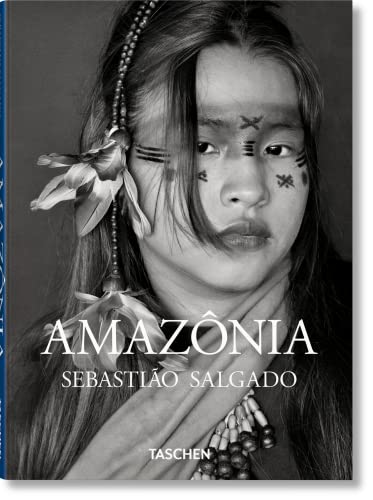 Black and white portrait of an Indigenous person with facial markings and floral adornments.