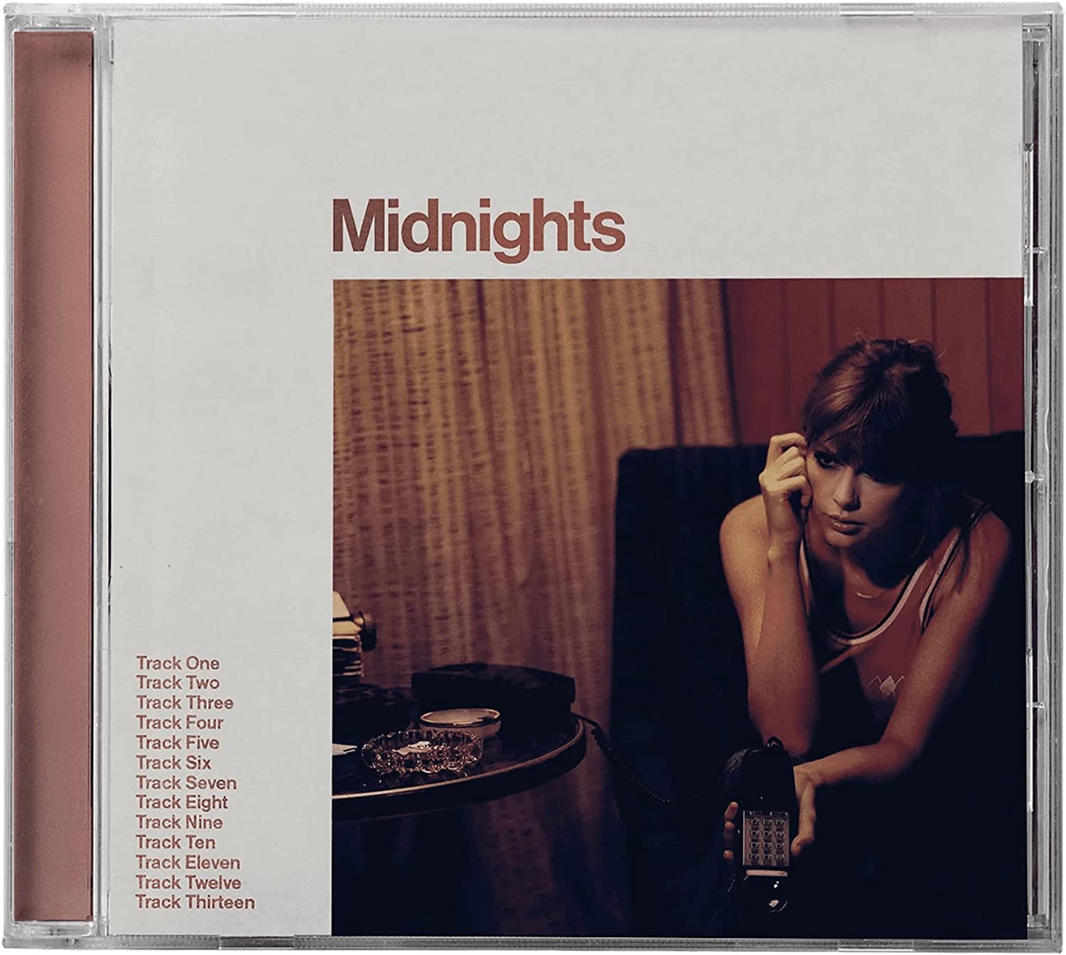 Taylor Swift's "Midnights" CD case with a portrait of the artist.
