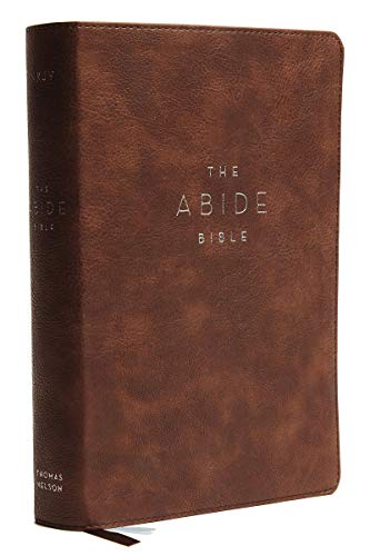 Brown leathersoft Bible, closed, with gold lettering and red page edges.