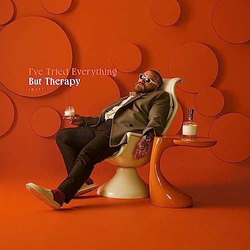 Teddy Swims album cover: man relaxing with drink, orange background.