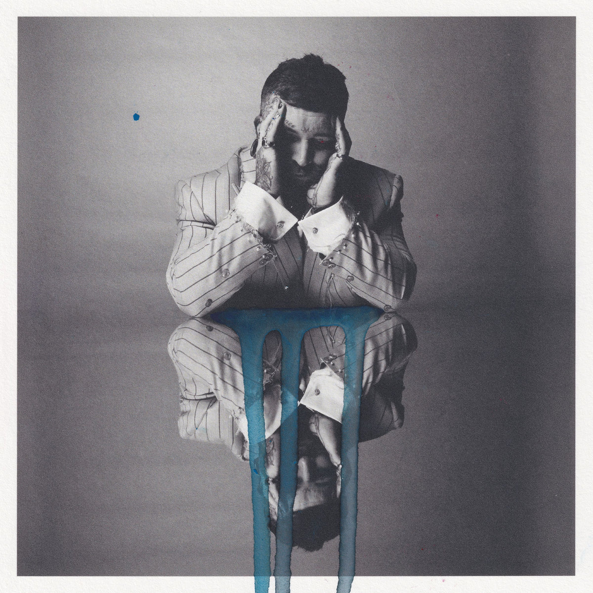 Man in pinstripe suit with blue liquid dripping downwards.