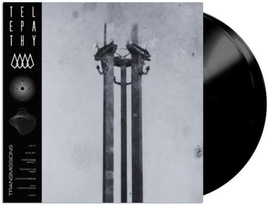 Vinyl record with album art depicting power lines against a cloudy sky.