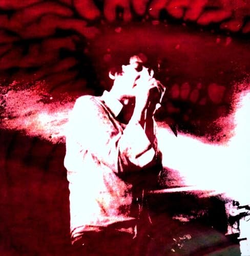 High-contrast red and white image of a person singing into a microphone.