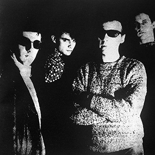Black and white photo of four people wearing sunglasses.
