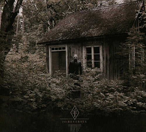 Dark, weathered cabin with a masked figure standing in the doorway.