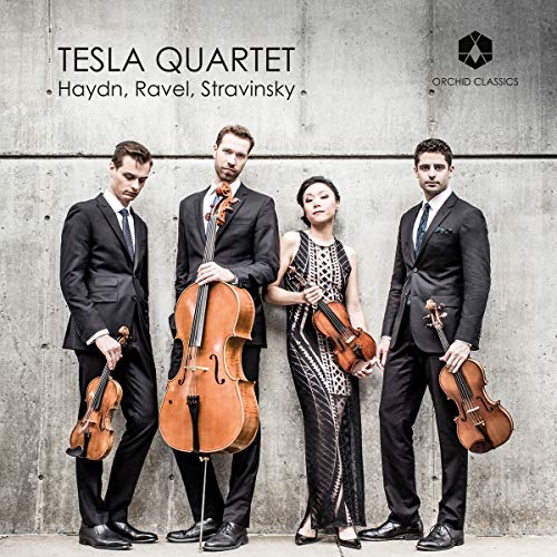 "Tesla Quartet CD cover featuring four musicians holding string instruments against a concrete wall."