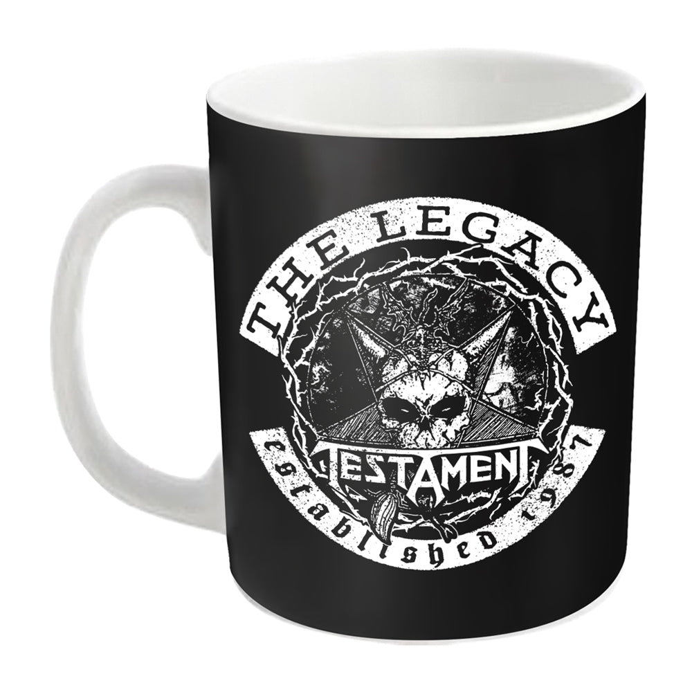 Black ceramic mug with white handle, featuring a skull and band logo.