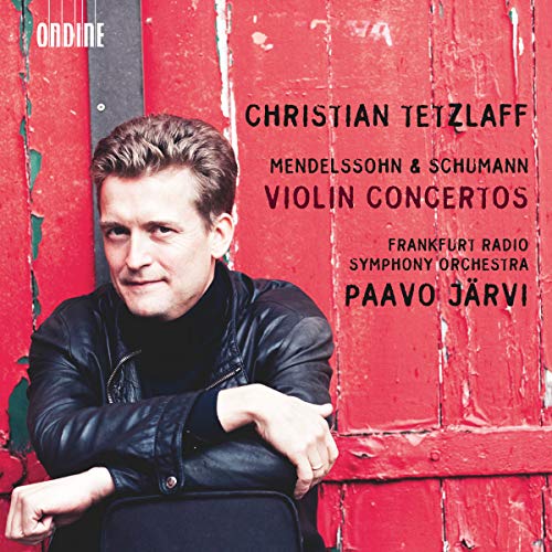 Christian Tetzlaff in a black jacket against a weathered red wooden background.