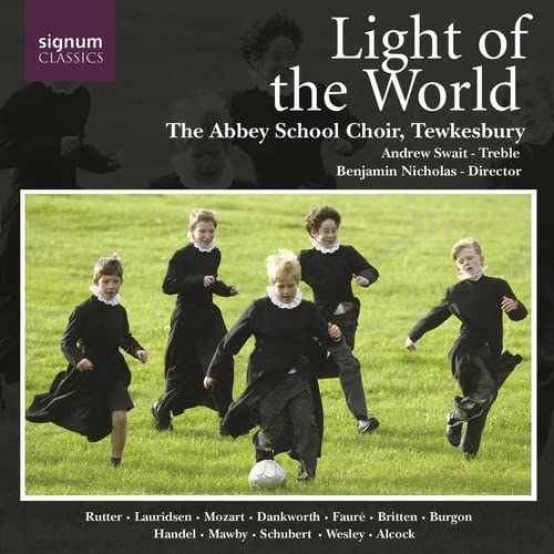 CD cover: boys in choir robes playing soccer in a field.