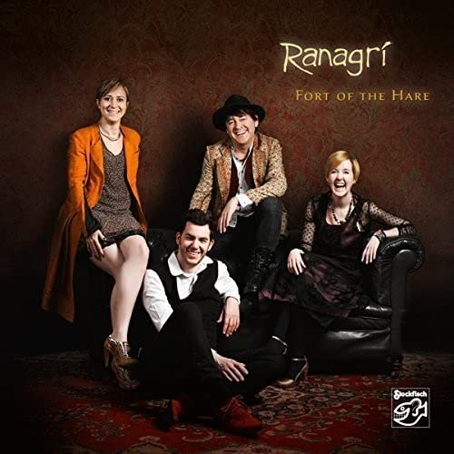 CD cover featuring four people posing on a patterned rug.