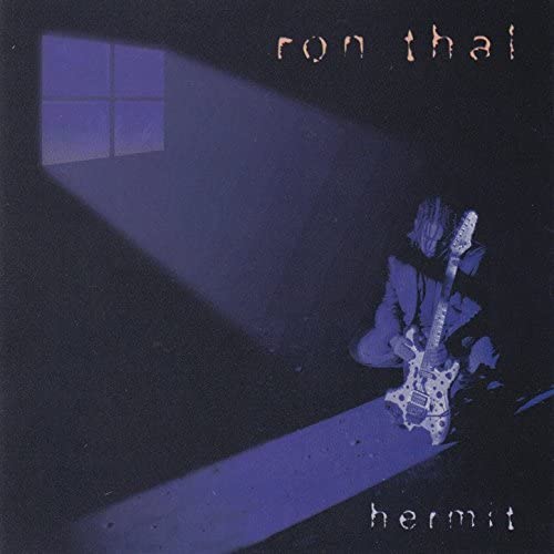 Dark album cover featuring a silhouetted guitarist and window light.