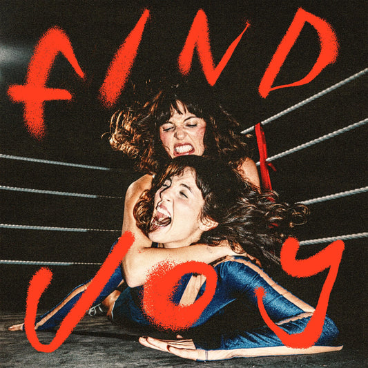 Two women wrestling in a boxing ring with large red text reading FIND JOY.