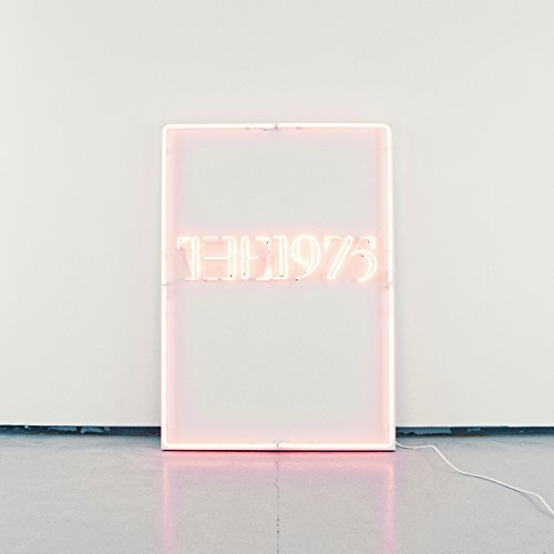 "Pink neon sign with text in a black frame, barcode in the corner."