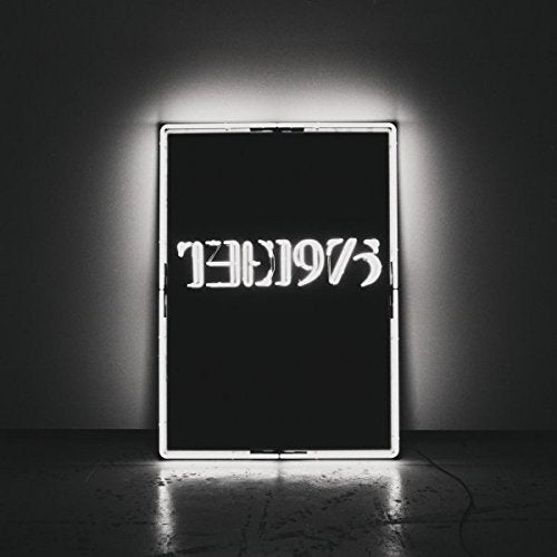 "CD case with black cover, white border, and upside-down 'The 1975' text, lit from within."