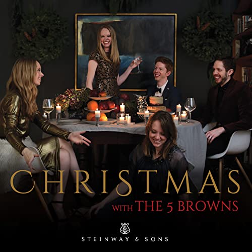 Five people around a table with festive decorations and the text "Christmas.