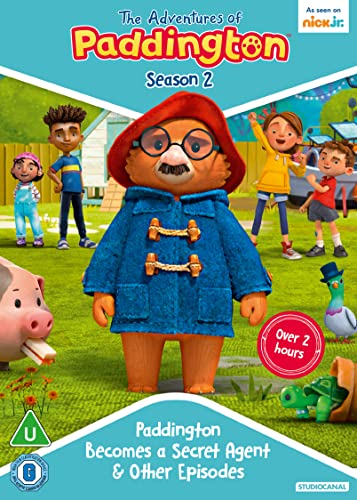 Paddington Bear stands in a park with friends, a pig, a pigeon, and turtle.