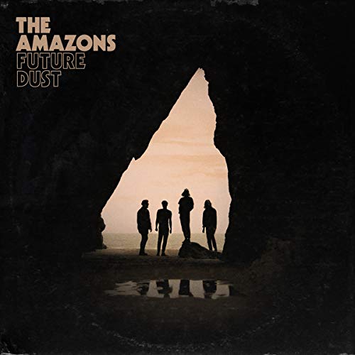 Silhouettes of four people standing on a beach viewed through a dark rock cave.