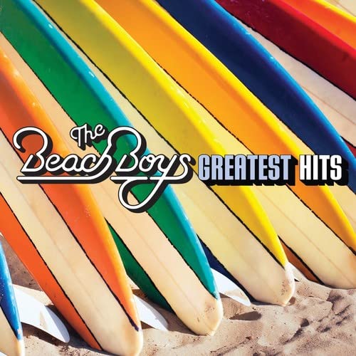 Colorful surfboards lined up on sand with The Beach Boys Greatest Hits text overlay.