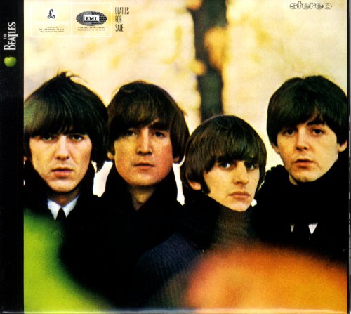 The Beatles posing for the album cover of Beatles For Sale against autumn trees.